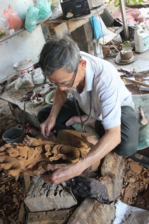 An artisanal wood sculptor in Baan Tawai, Thailand
