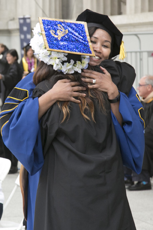 Walker hugging a graduate at this spring's commencement. Photo by Jim Block