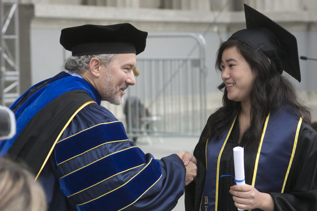 Berkeley Haas Dean, Richard Lyons congratulates a graduate at this year's commencement. Photo by Jim Block