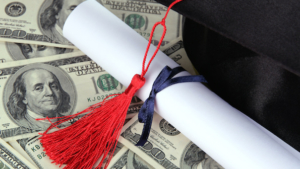 Graduation hat and scroll on money background