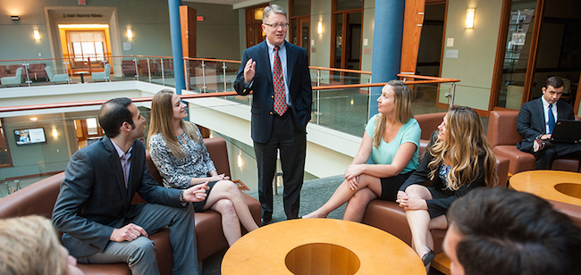 A professor with students at Georgetown University's McDonough School of Business